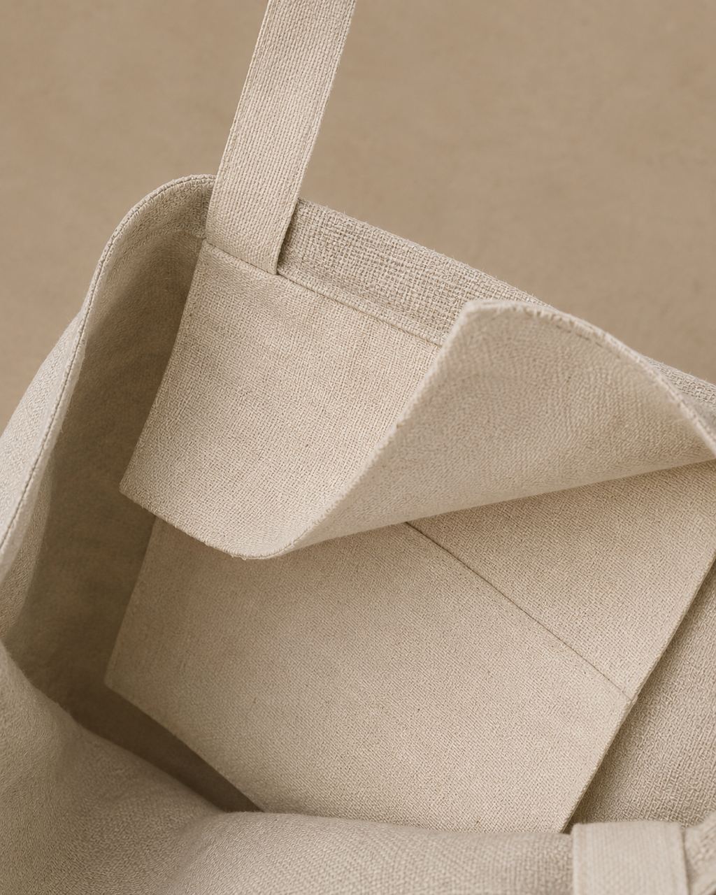 Close-up of a beige cream canvas tote bag showing the interior pocket, stitched edge, against a matching neutral background, Hemp Horizon