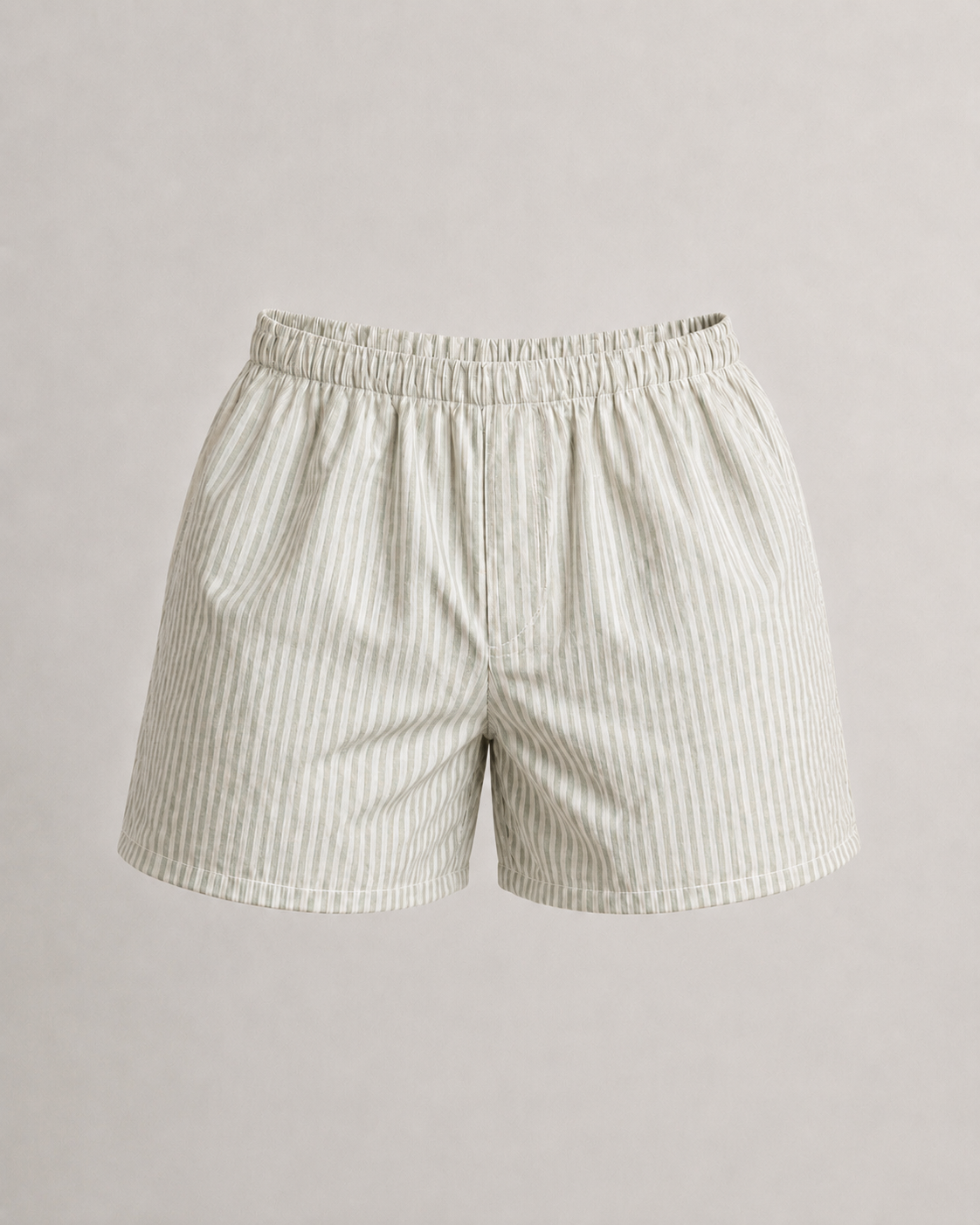 A pair of mens boxers with a vertical pinstripe pattern in cream and light beige, featuring an elastic waistband, photographed against a neutral light gray background. Hemp Horizon