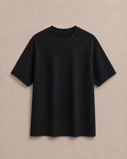 A plain black Hemp and Organic cotton short-sleeve t-shirt laid flat against a textured beige background. Hemp Horizon