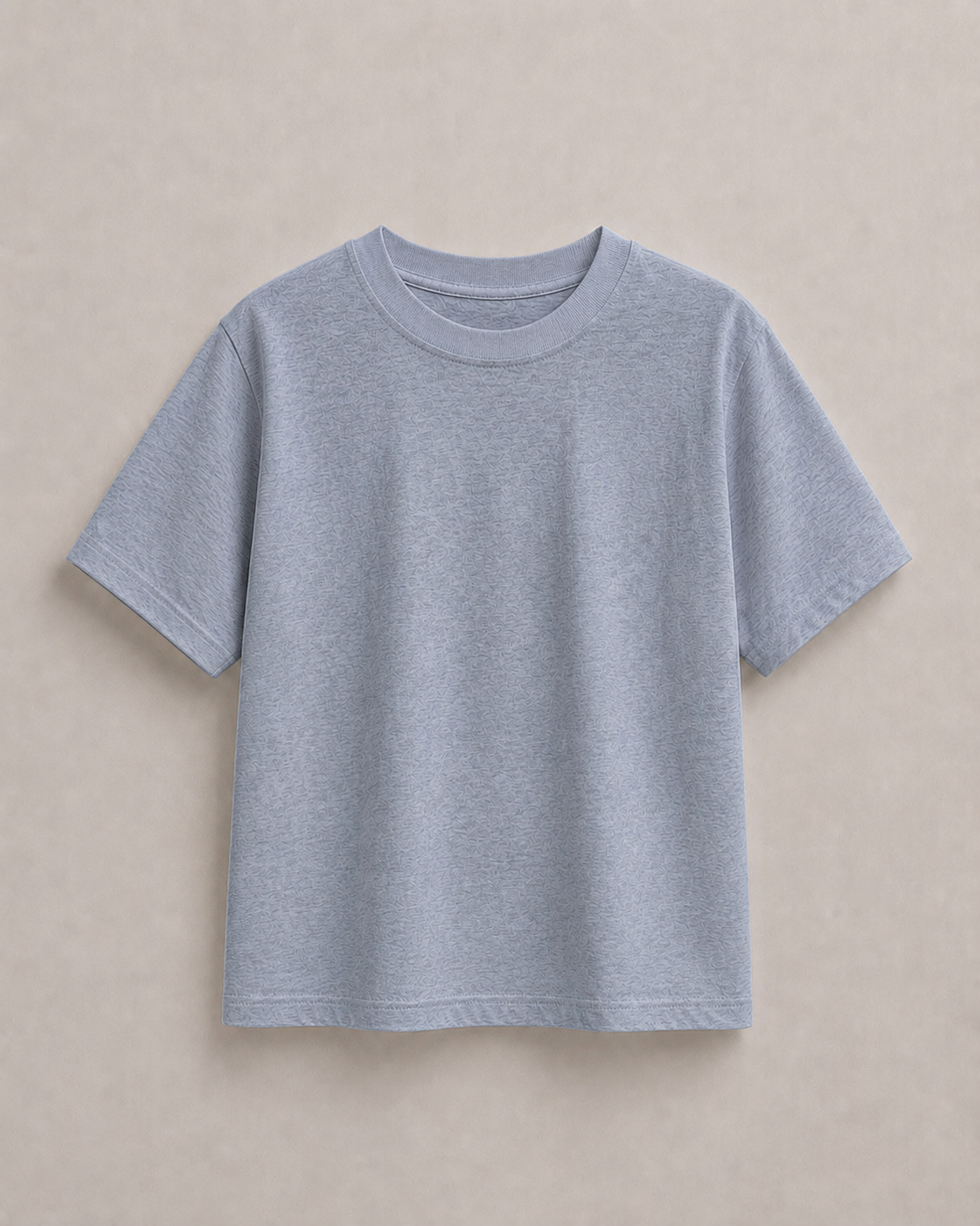 A light grey short-sleeve kids t-shirt laid flat against a neutral beige background. Hemp Horizon