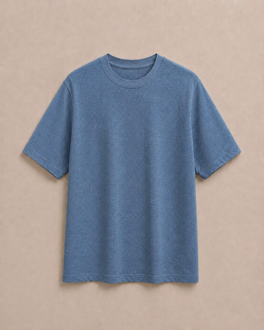 A Pure Hemp slate blue short-sleeve  t-shirt laid flat against a solid beige background. Hemp Horizon