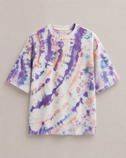 A short-sleeve ice dyed t-shirt with a purple, blue, and orange ice-dye pattern on a white base, displayed flat against a neutral beige background. Hemp Horizon