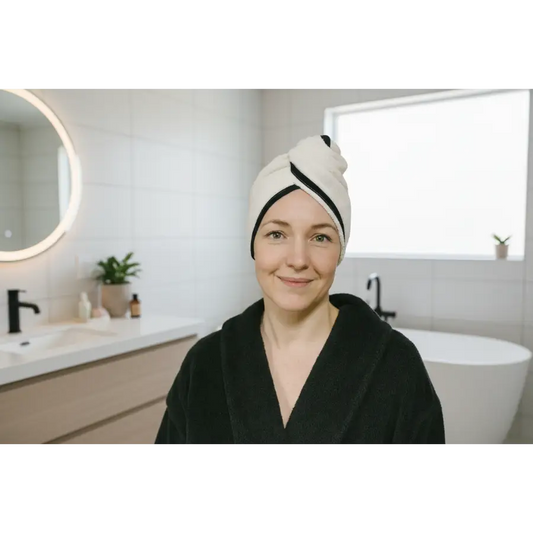 Woman wearing a white towel on her head with black trim, standing against a neutral background. Hemp Horizon